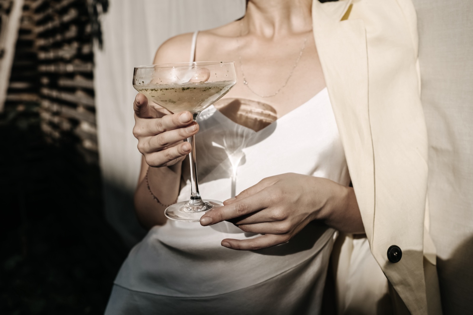 A champagne coupe held at an evening event